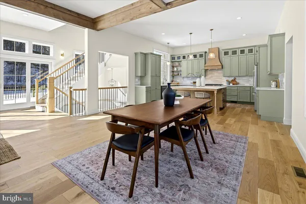 a living room with furniture a rug and a floor to ceiling window