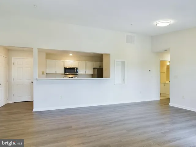 a view of a kitchen cabinets and a wooden floor