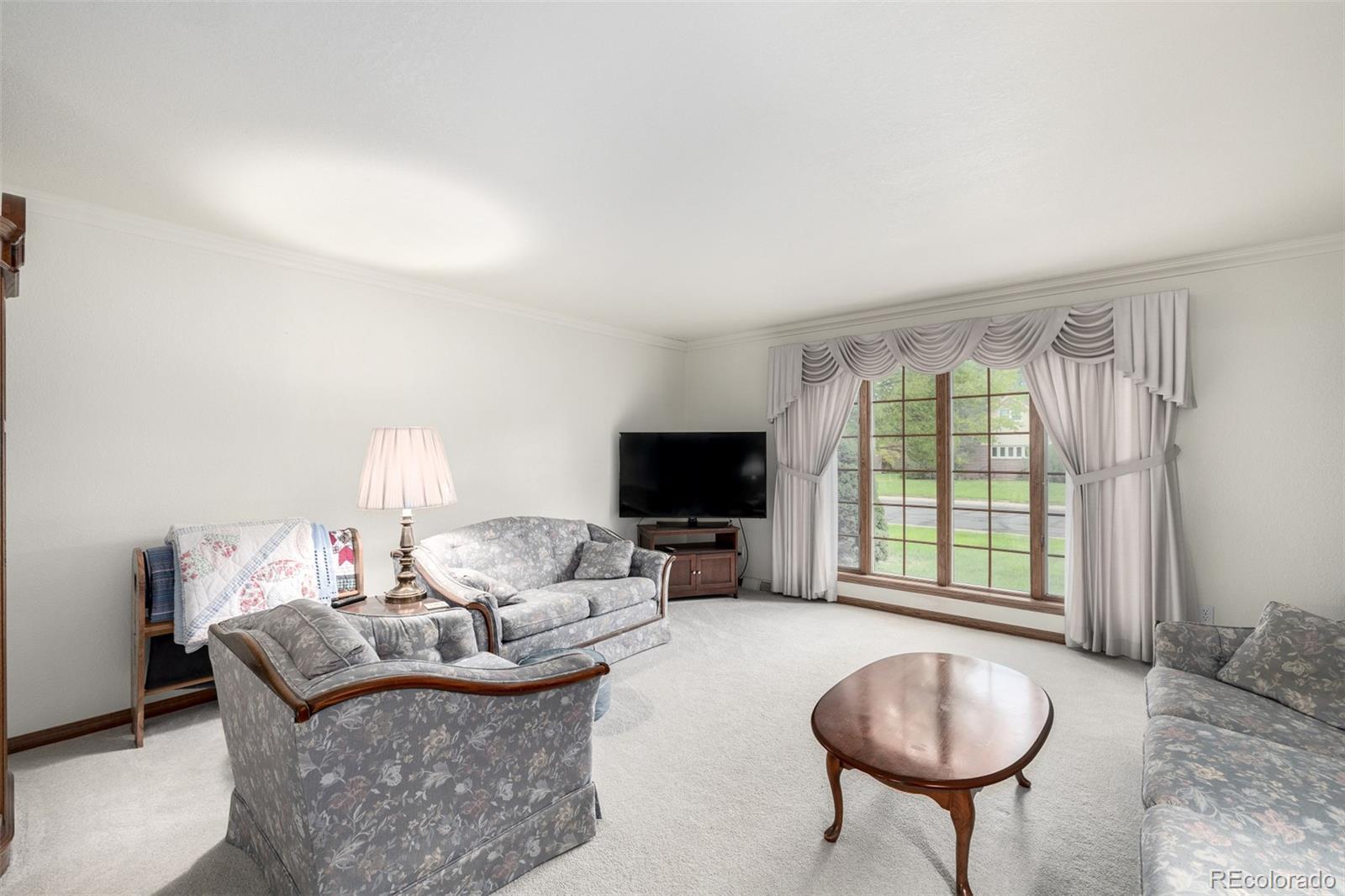 909 Fairhurst Street Sterling, CO 80751 - Photo 13 of 50 a living room with furniture and a flat screen tv