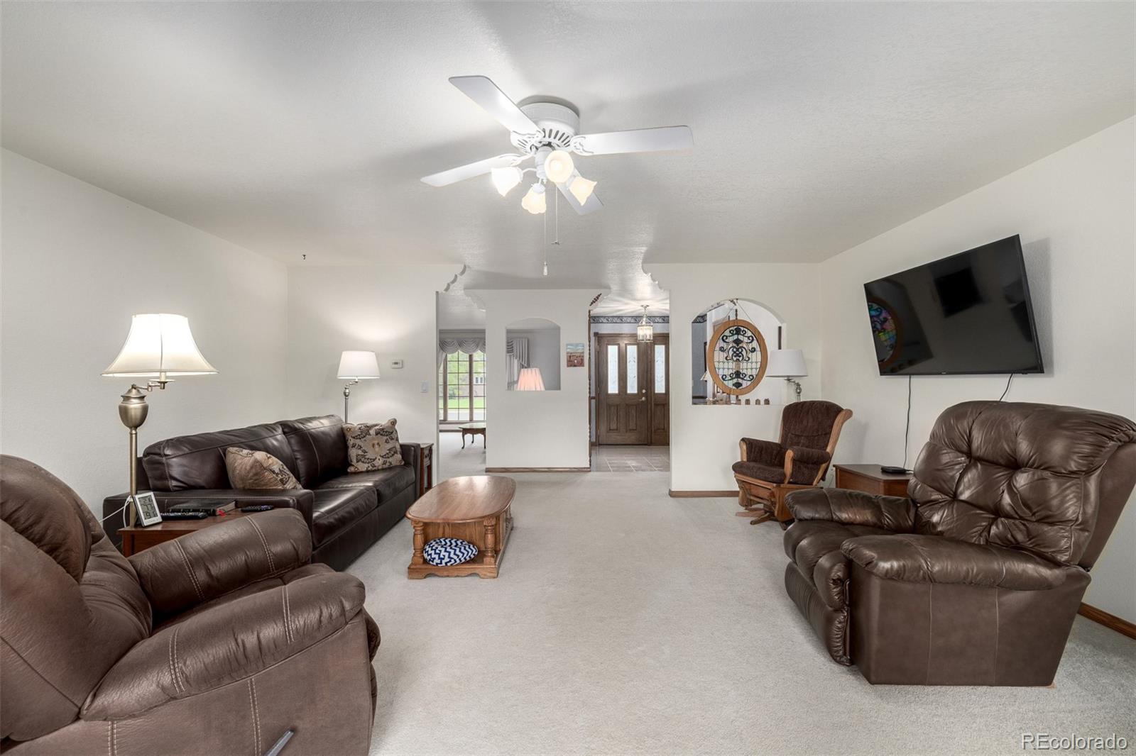 909 Fairhurst Street Sterling, CO 80751 - Photo 16 of 50 a living room with furniture and a flat screen tv