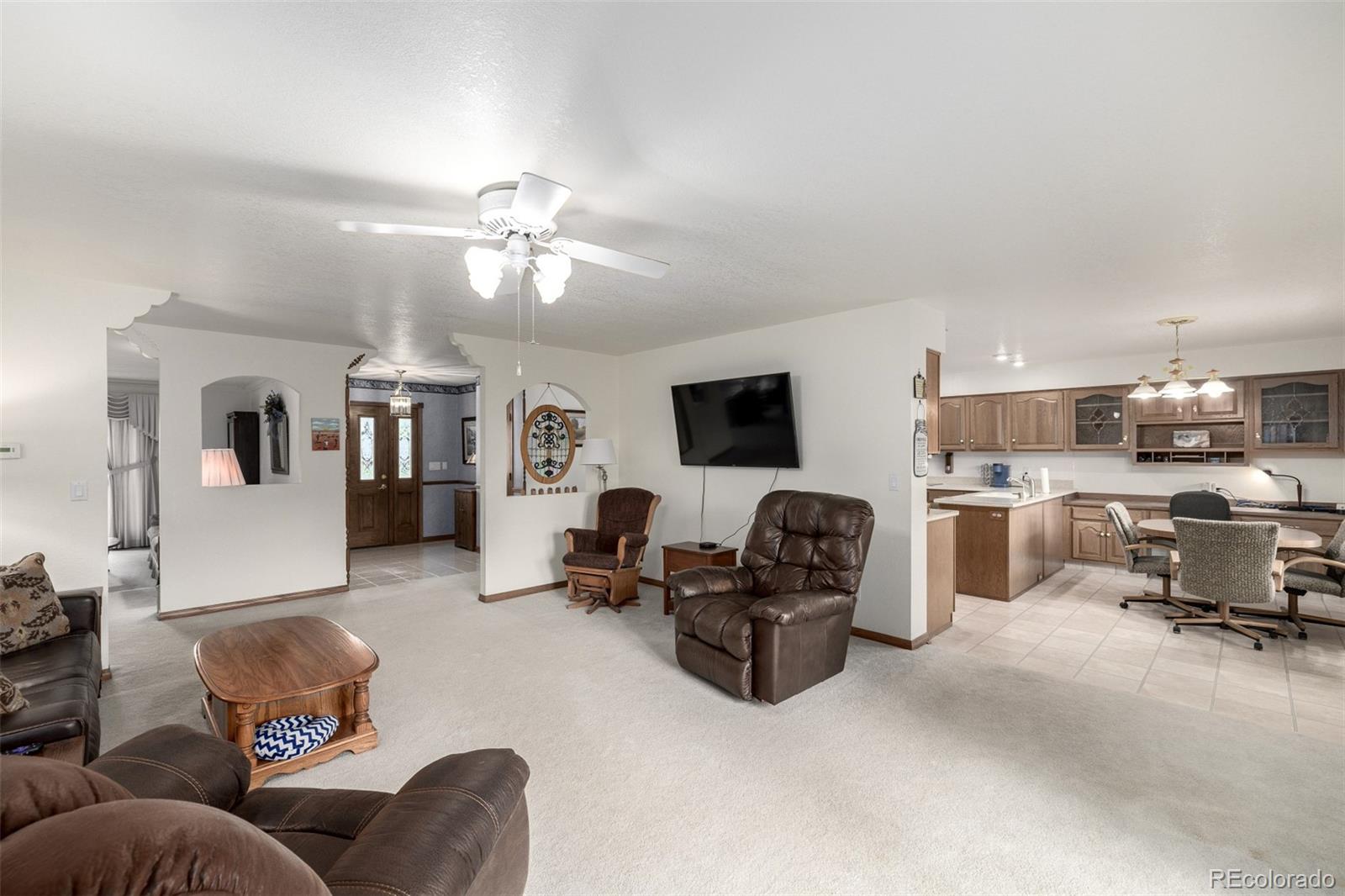 909 Fairhurst Street Sterling, CO 80751 - Photo 17 of 50 a living room with furniture and a flat screen tv