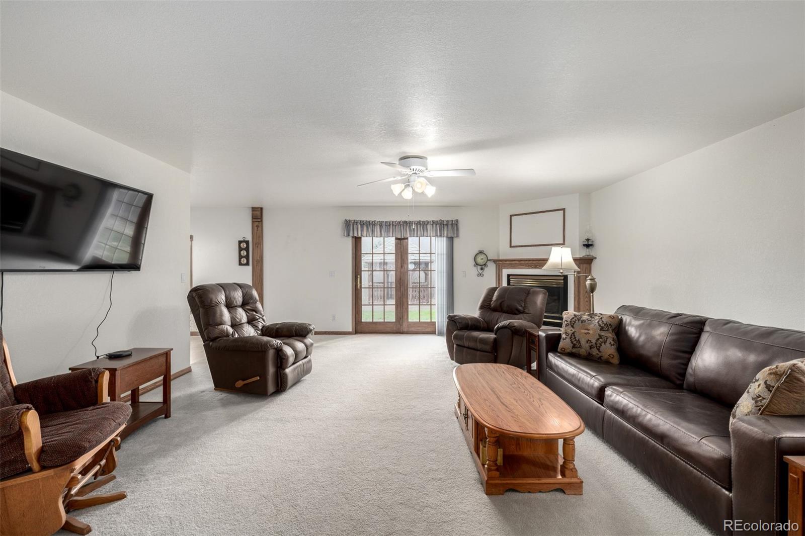 909 Fairhurst Street Sterling, CO 80751 - Photo 18 of 50 a living room with furniture a flat screen tv and a window
