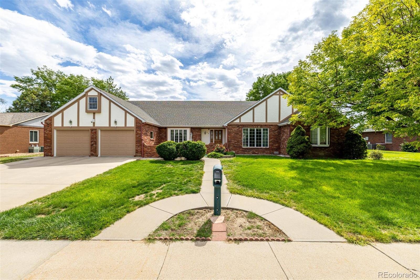 909 Fairhurst Street Sterling, CO 80751 - Photo 2 of 50 a front view of a house with a yard