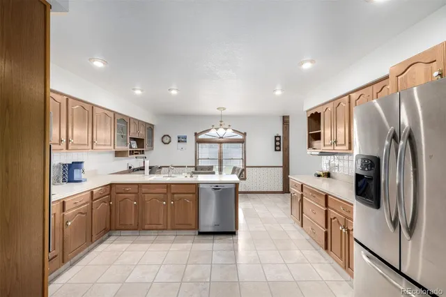 a kitchen with a sink stainless steel appliances and cabinets