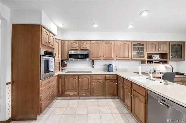 a kitchen with stainless steel appliances granite countertop a sink and cabinets