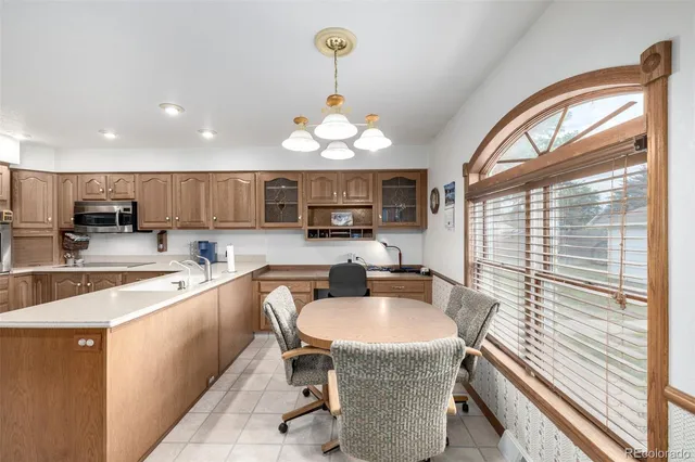 a kitchen with stainless steel appliances granite countertop a sink a stove and a refrigerator