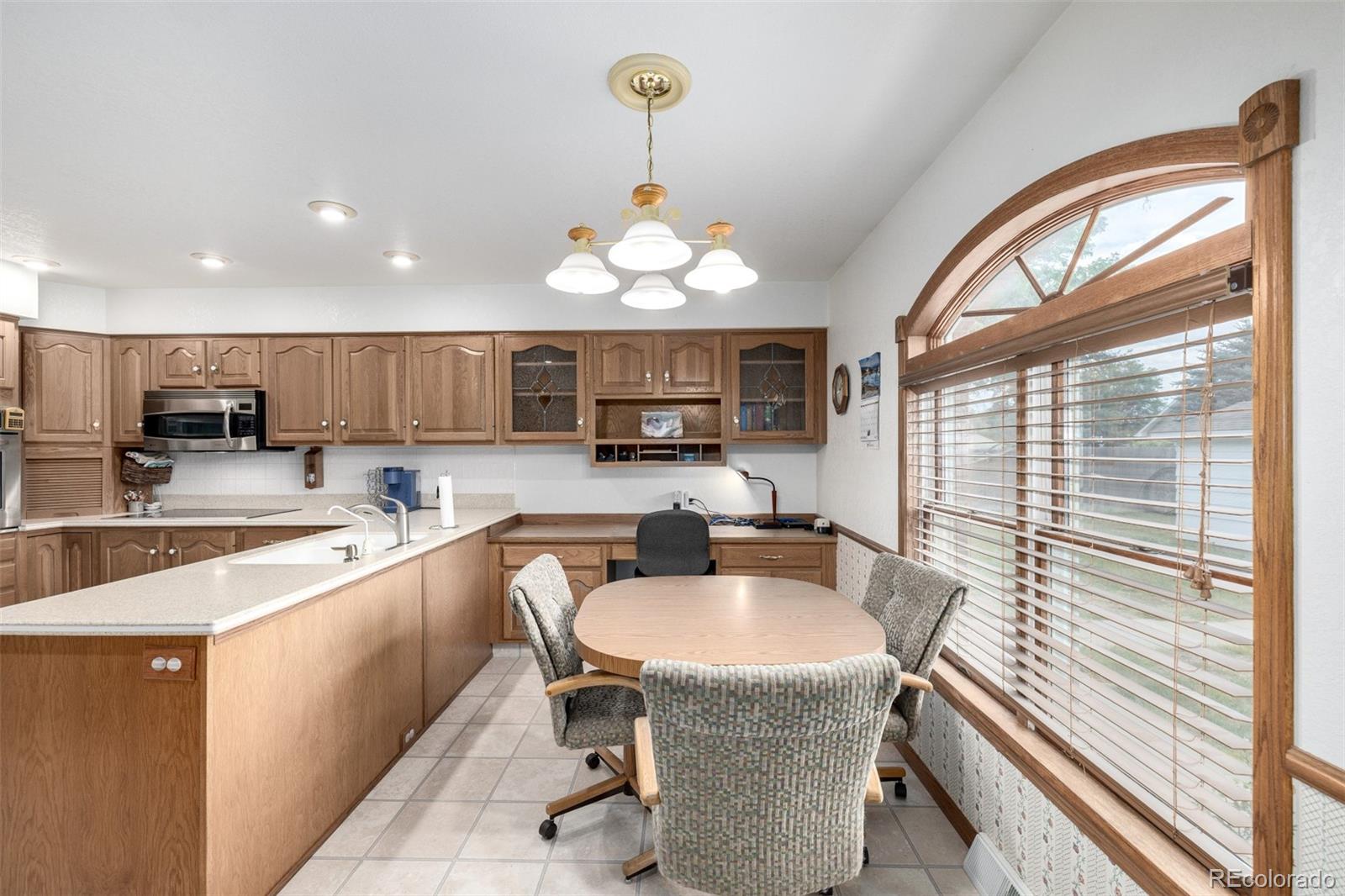 909 Fairhurst Street Sterling, CO 80751 - Photo 25 of 50 a kitchen with stainless steel appliances granite countertop a sink a stove and a refrigerator