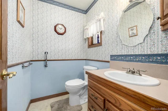 a bathroom with a sink mirror and toilet