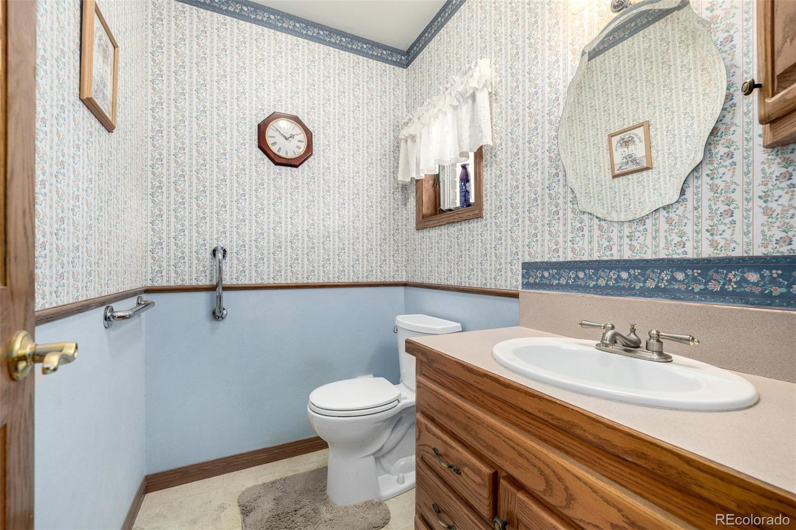 909 Fairhurst Street Sterling, CO 80751 - Photo 26 of 50 a bathroom with a sink mirror and toilet