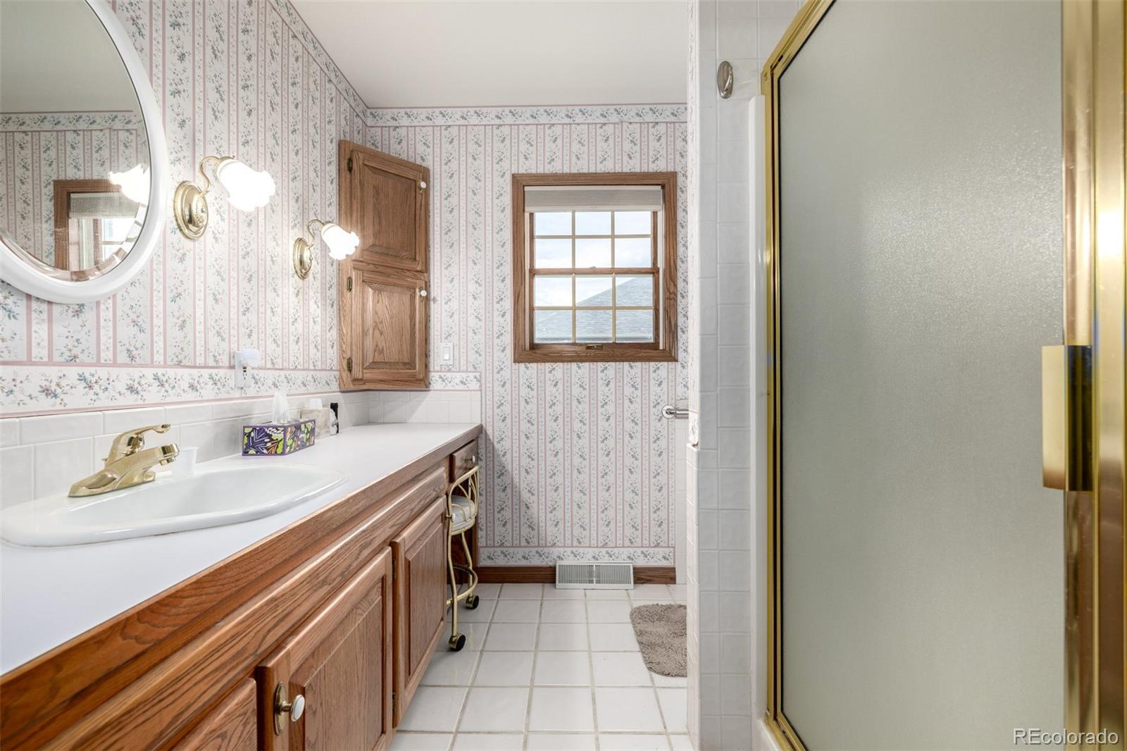 909 Fairhurst Street Sterling, CO 80751 - Photo 30 of 50 a bathroom with a sink a vanity and a mirror