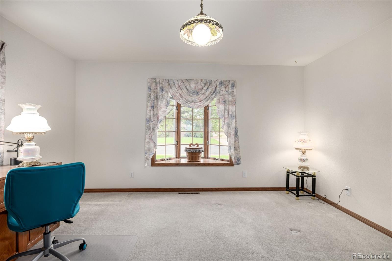 909 Fairhurst Street Sterling, CO 80751 - Photo 33 of 50 a view of an empty room with a window and a dresser in it