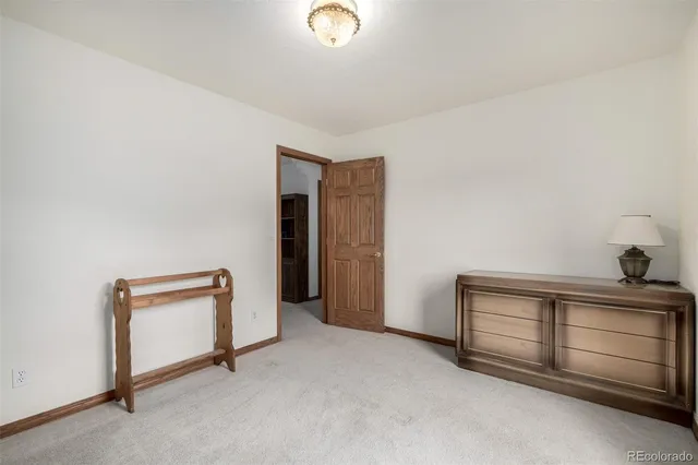 a view of an empty room with a cabinet