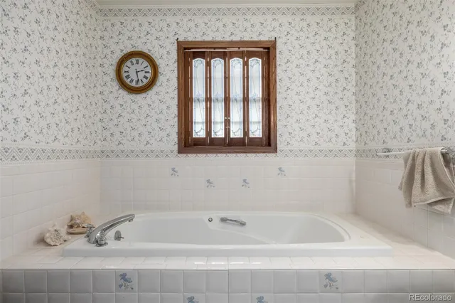 a bathroom with a bathtub and a window