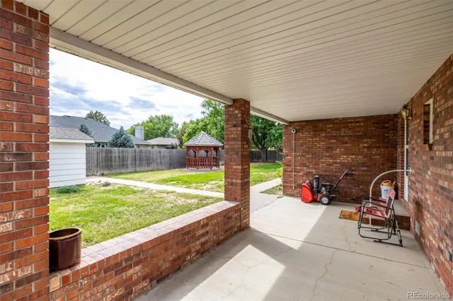 a view of yard from deck with patio