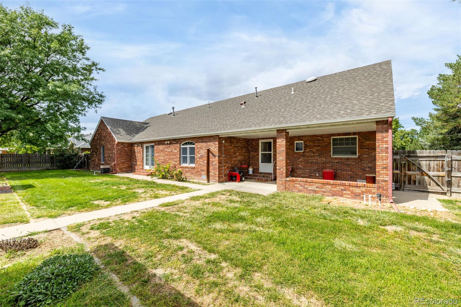 909 Fairhurst Street Sterling, CO 80751 - Photo 42 of 50 a view of a house with a yard and sitting area