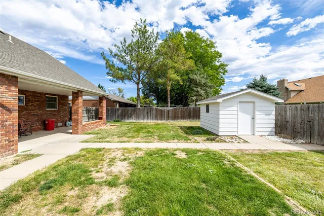 a view of a house with a yard and garage