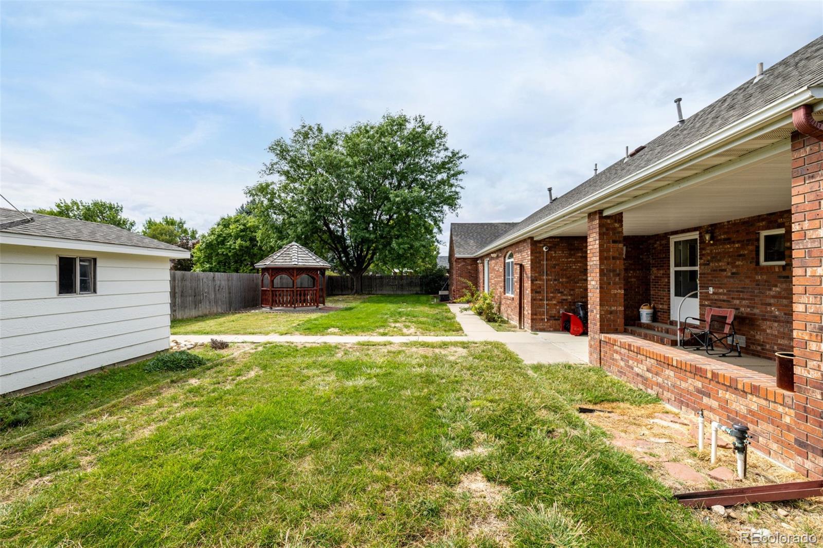 909 Fairhurst Street Sterling, CO 80751 - Photo 50 of 50 a view of a house with a yard and sitting area