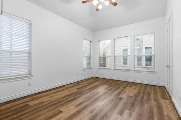 a bedroom with bed and a large window