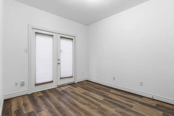 a bedroom with bed and a potted plant