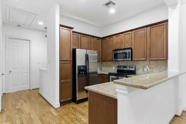 a kitchen with a refrigerator sink and microwave