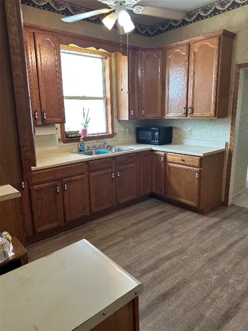 a kitchen with a sink cabinets and window