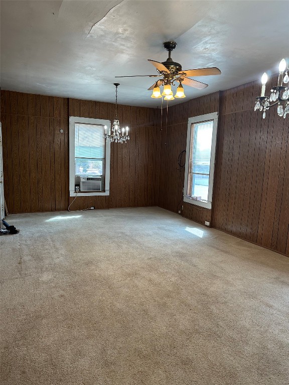 5416 Rogers Lane Austin, TX 78724 - Photo 3 of 18 an empty room with a chandelier fan and windows