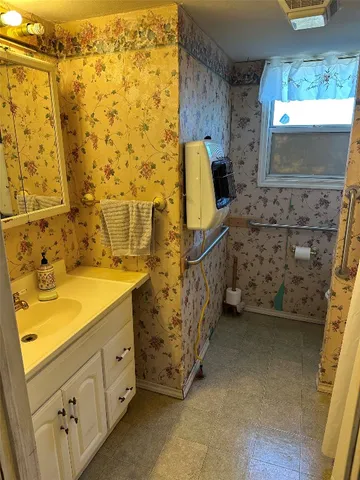 a bathroom with a sink and a mirror