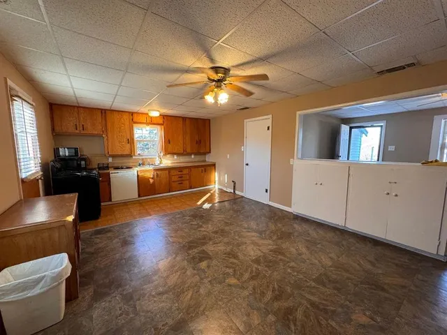 a view of a kitchen with a stove cabinets and a kitchen view