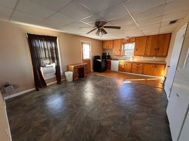 a view of a kitchen with a sink dishwasher refrigerator stove and cabinets