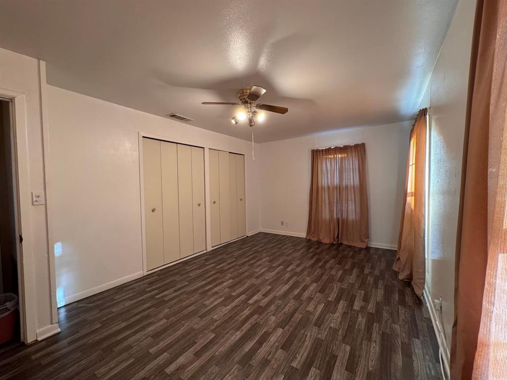 702 4th Street Lawn, TX 79530 - Photo 8 of 10 wooden floor in an empty room with a window