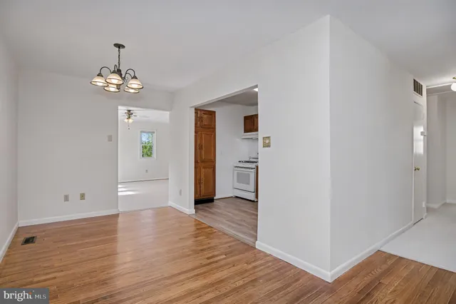 a dining room with furniture a table and kitchen view
