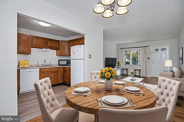 a kitchen with a wooden floor and a refrigerator