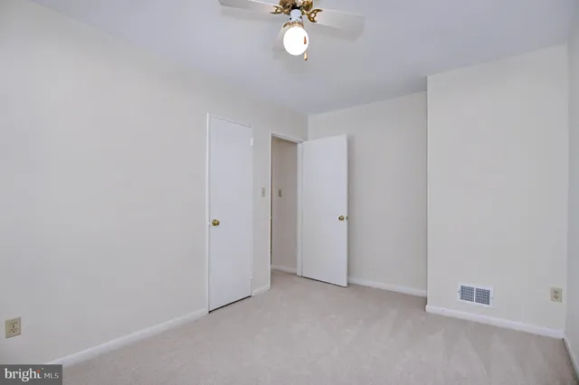 a view of an empty room with wooden cabinet