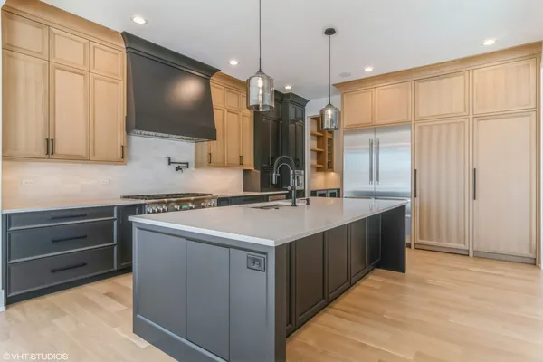 a kitchen with a sink stove and cabinets