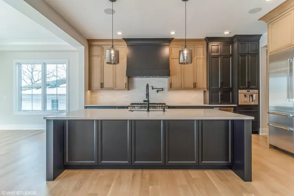 a kitchen with a sink and refrigerator