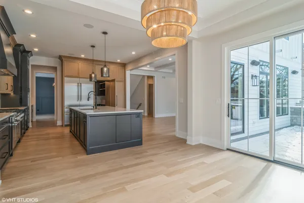 a large kitchen with a large counter top appliances and cabinets