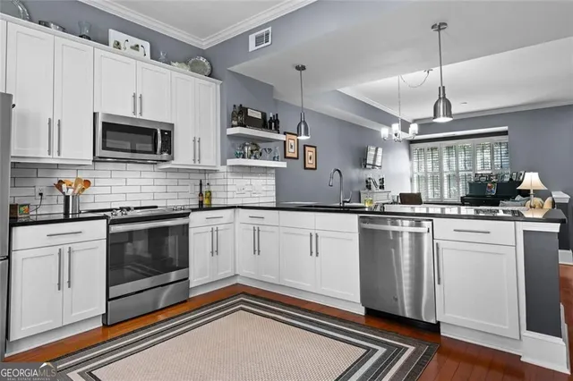 a kitchen that has a sink and a stove in it