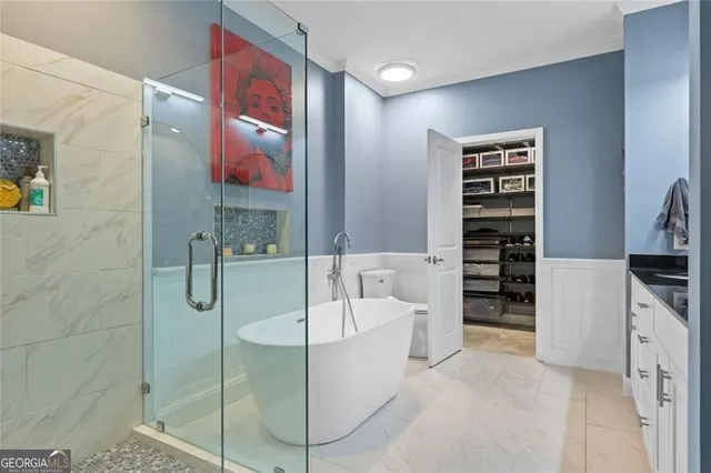 a kitchen with stainless steel appliances granite countertop a stove and a view of living room