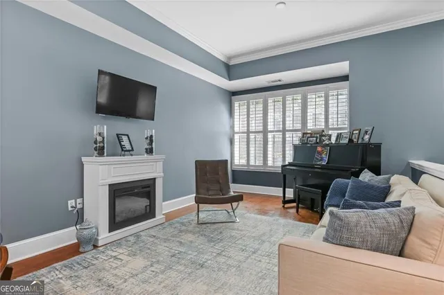 a living room with furniture a flat screen tv and a fireplace