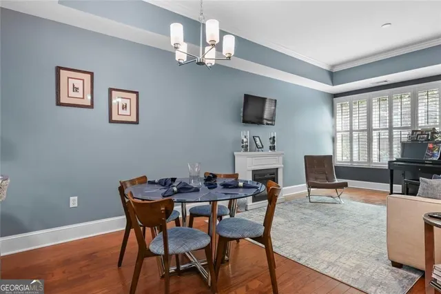 a dining room with furniture and wooden floor
