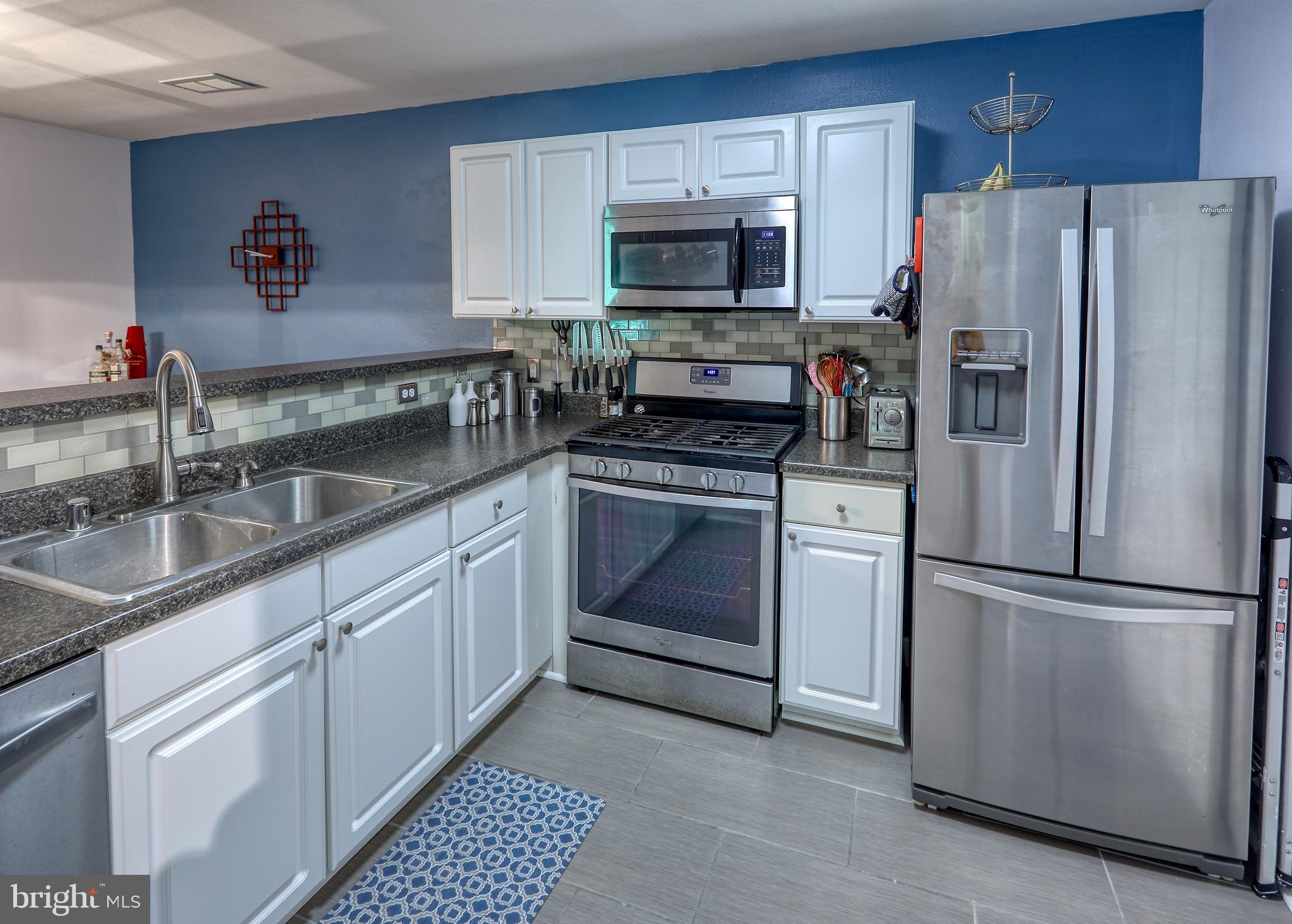 302 Canterbury Road, Unit F Bel Air, MD 21014 - Photo 2 of 26 a kitchen with granite countertop a refrigerator stove and sink