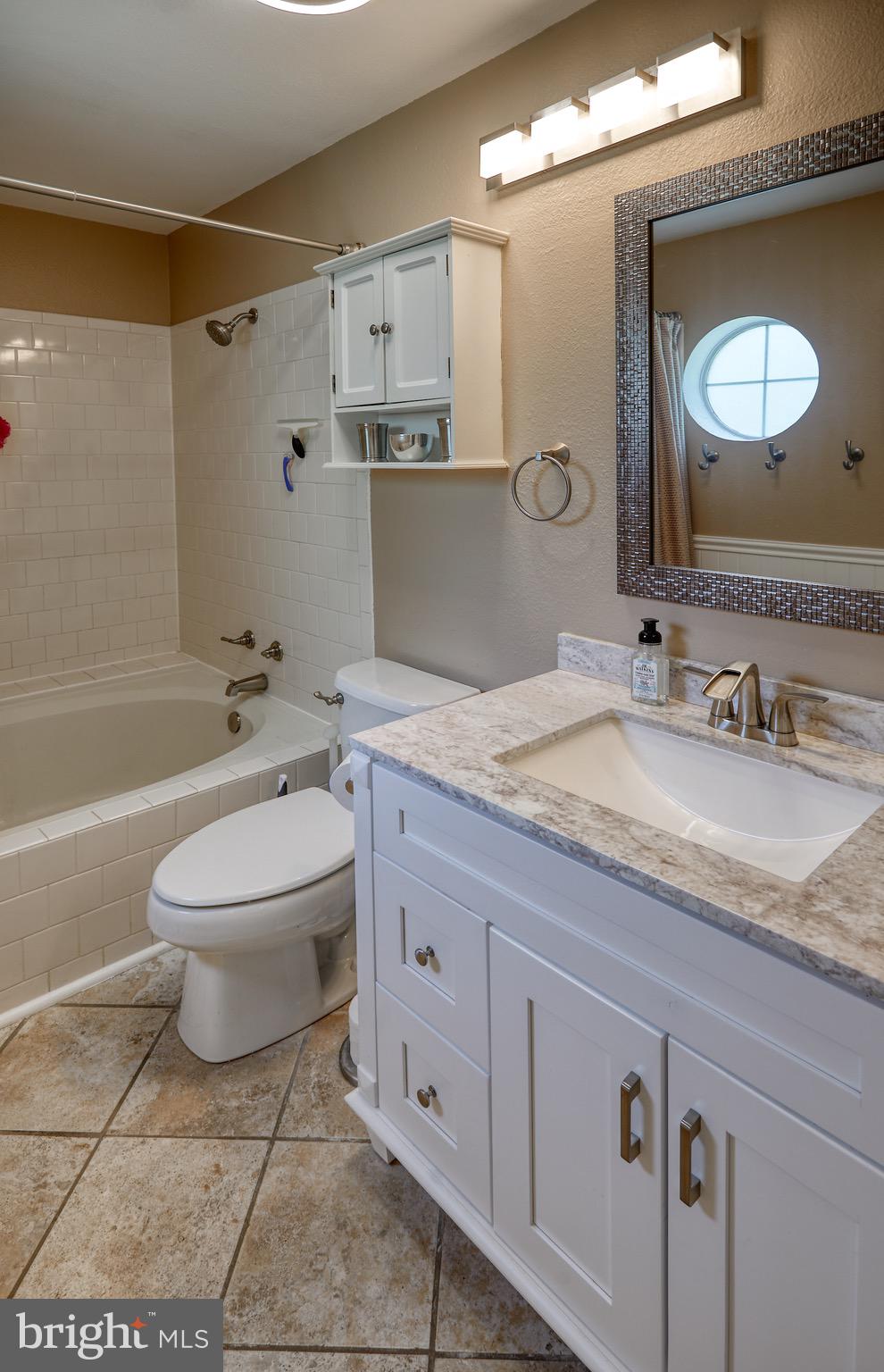 302 Canterbury Road, Unit F Bel Air, MD 21014 - Photo 13 of 26 a bathroom with a granite countertop toilet a sink and a mirror