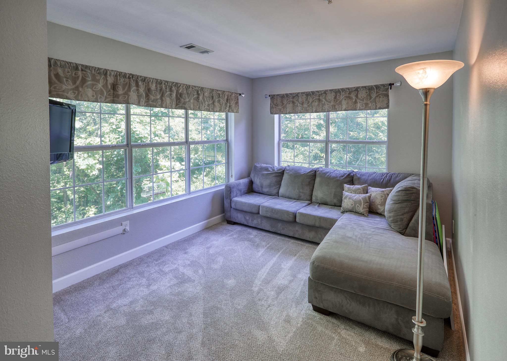 302 Canterbury Road, Unit F Bel Air, MD 21014 - Photo 9 of 26 a living room with furniture and a large window