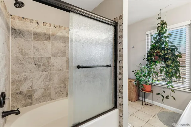 a bathroom with a shower and a plant