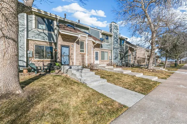 a view of residential houses with snow on the road