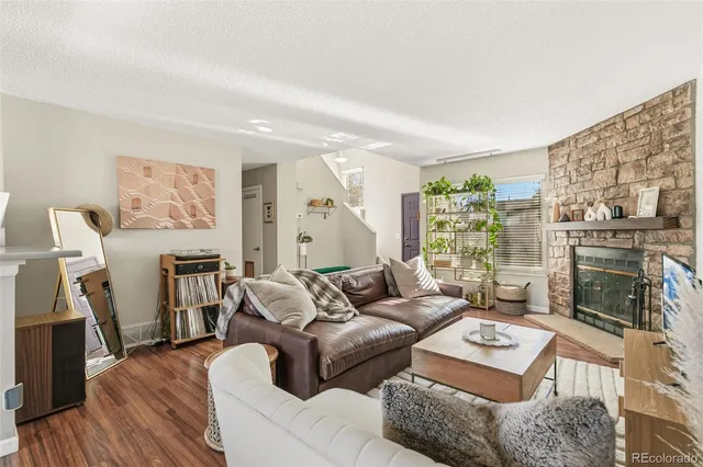 a living room with furniture a fireplace and a flat screen tv