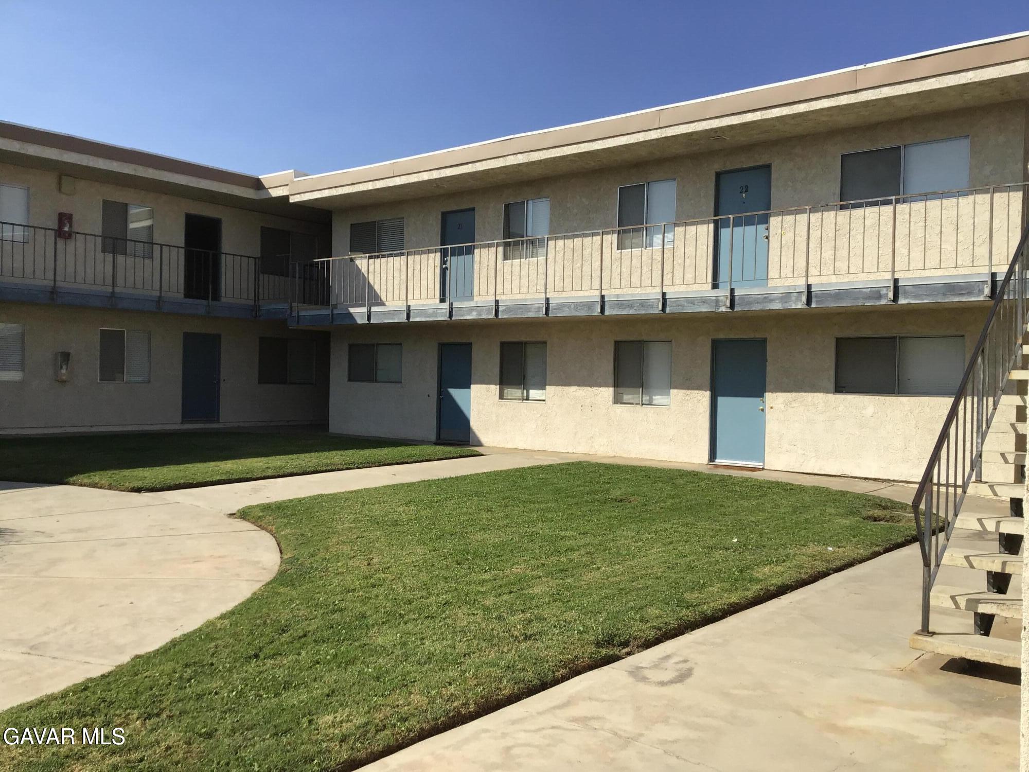 5036 West Ave L8, Unit 5 Quartz Hill, CA 93536 - Photo 3 of 9 a front view of a house with a yard
