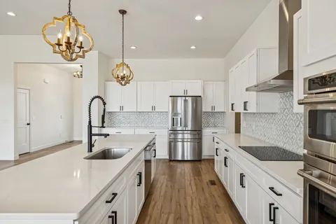 a view of a kitchen with wooden floor and a kitchen