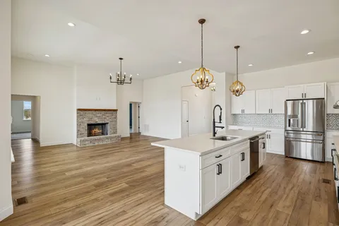 a view of a kitchen with a stove cabinets and wooden floor