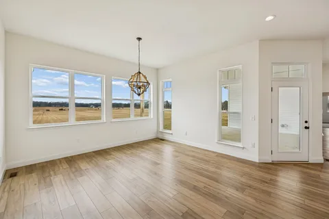 a spacious bathroom with a double vanity sink a mirror and a bathtub